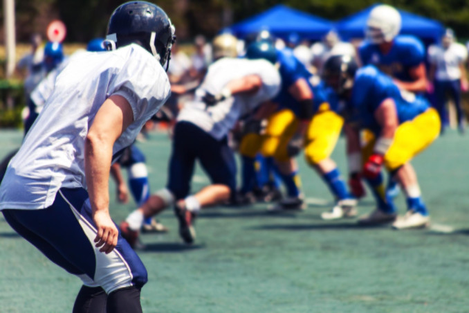 Football player watching tackle: Babcock Personal Injury blog